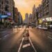 A man running across a city street during a golden sunset, showing strong photographic composition.