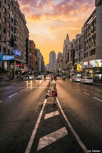 A man running across a city street during a golden sunset, showing strong photographic composition.